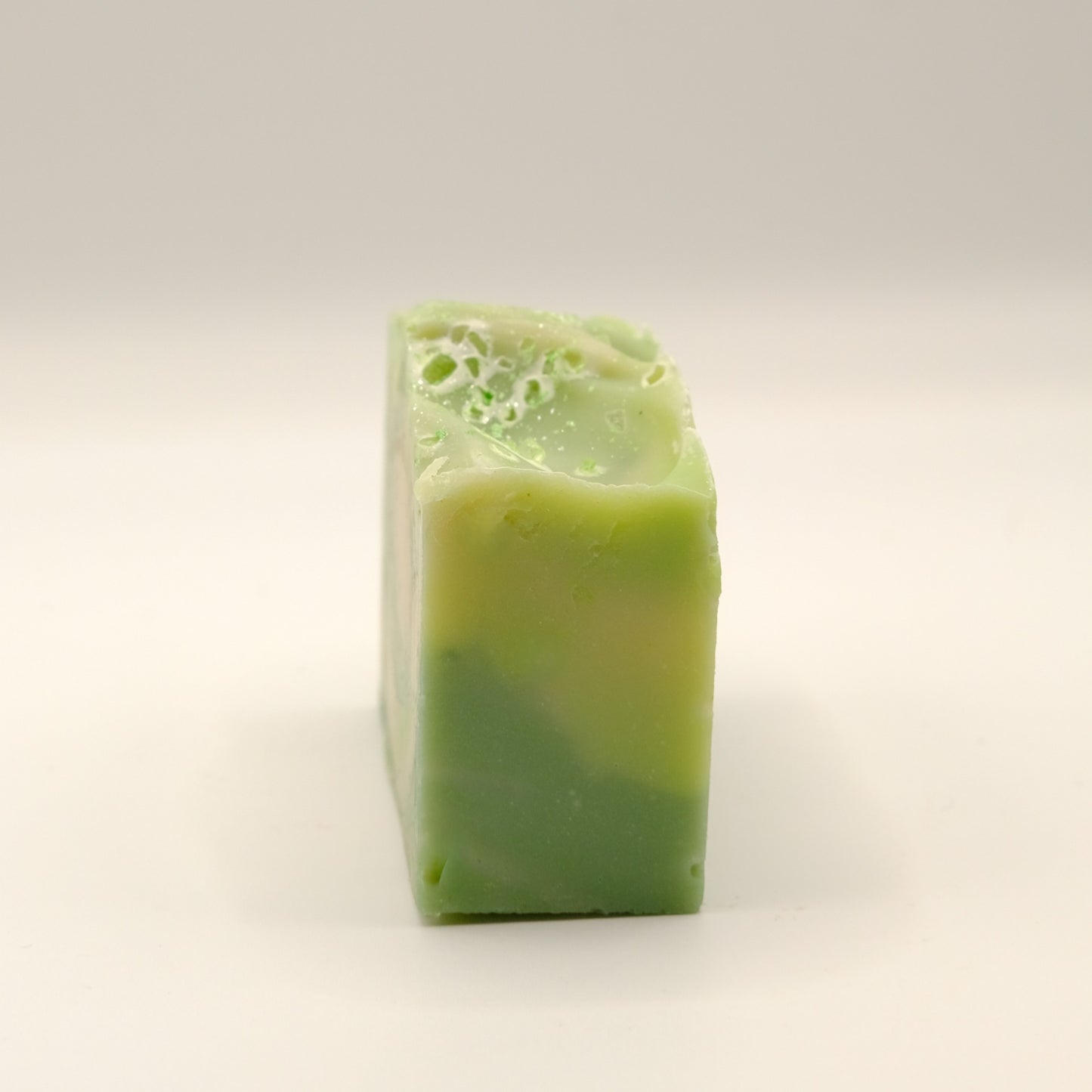 Dark and light green soap bar on a light background