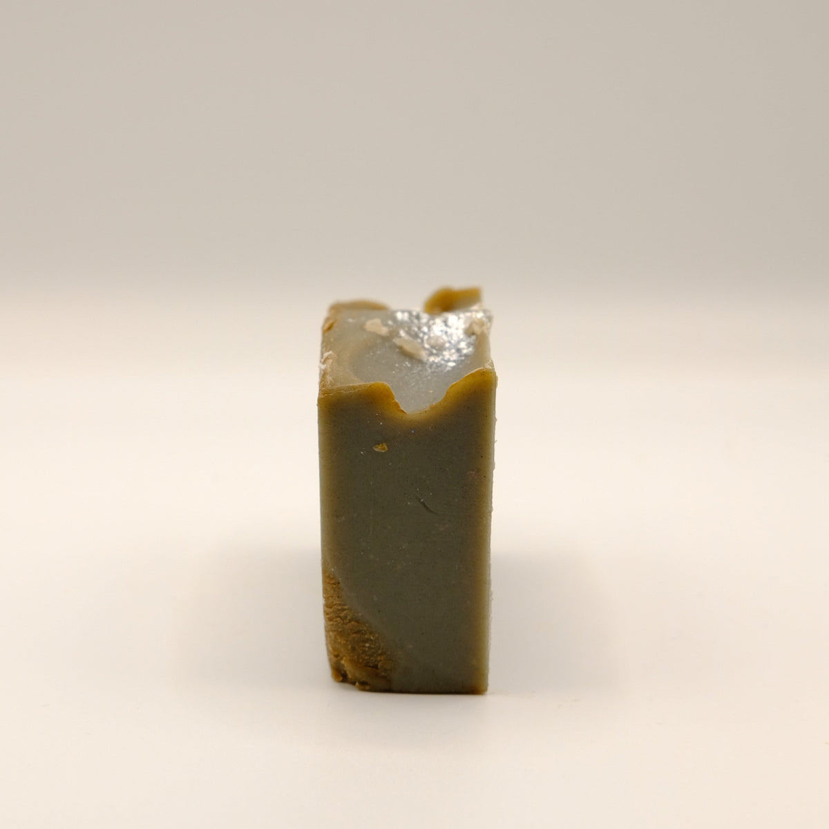 Rectangular bar of soap with a textured surface on a light background