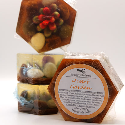 Hexagonal soap with desert garden design and 'Squiggly Sudsery' branding on a white background