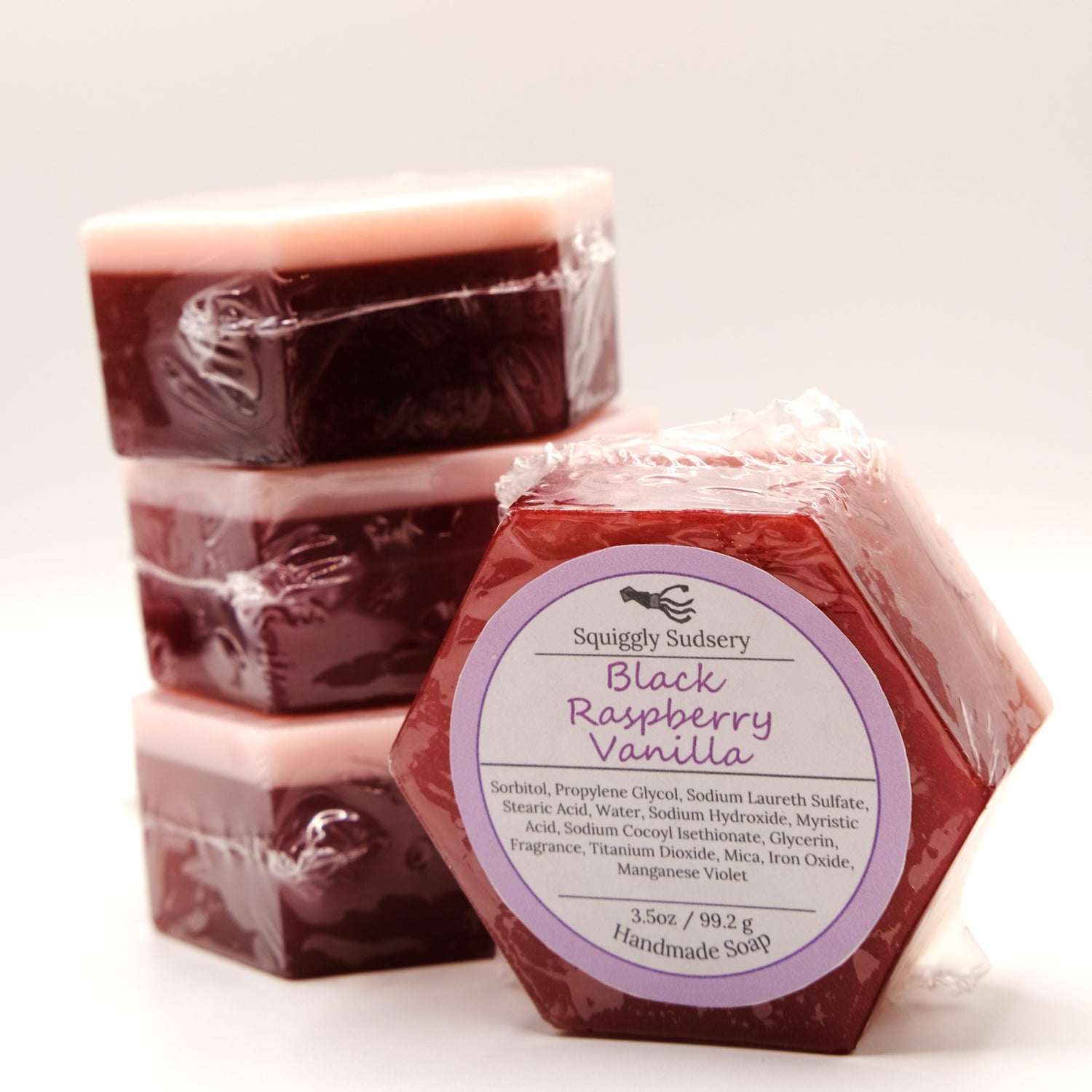 Red hexagonal soap bars with a label that reads 'Black Raspberry Vanilla' on a white background