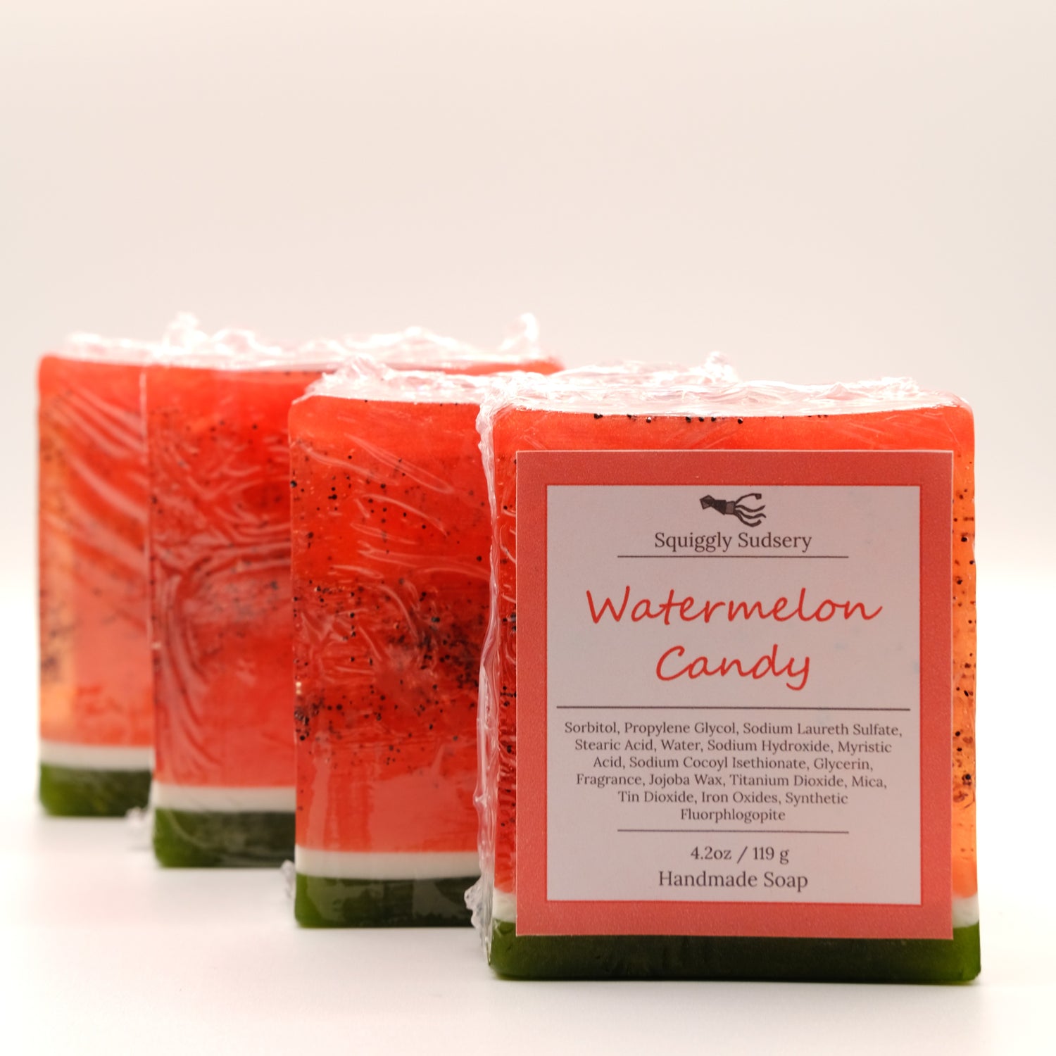 Four wrapped watermelon candy soap bars with a label on a white background