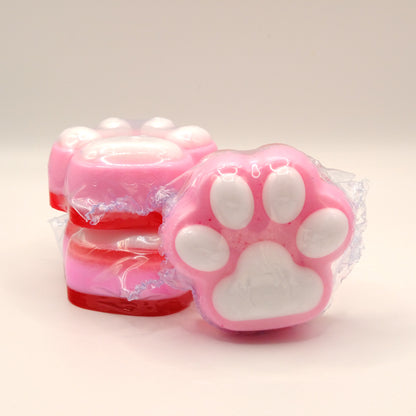 Pink paw-shaped soaps with white centers on a light background