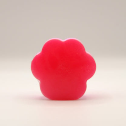 Red soap bar with a paw print design on a beige background