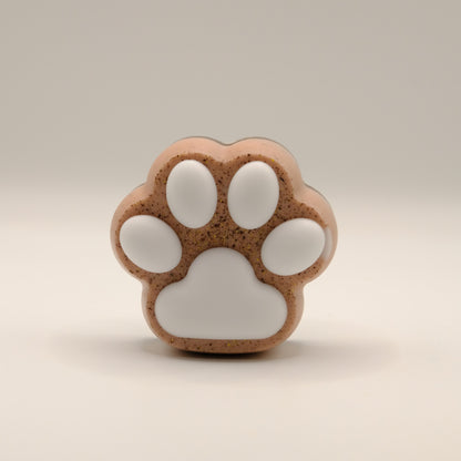 Brown soap bar shaped like a paw print on a beige background