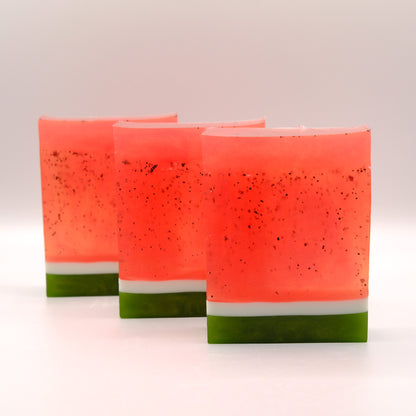 Three layered soap bars resembling watermelon on a white background