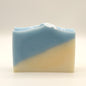 Two-toned blue and beige soap bar on a light gray background