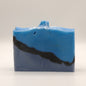 Blue and black layered soap bar with a textured top and silver accents on a white background