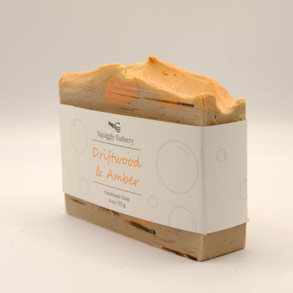 Bar of soap with a textured top and 'Squiggly Sudsery' branding on a light background