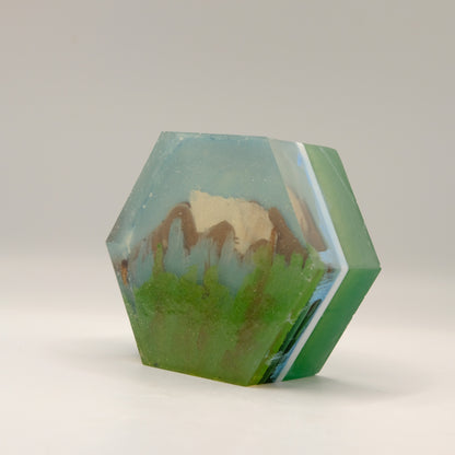 Hexagonal soap with mountain landscape design on a white background