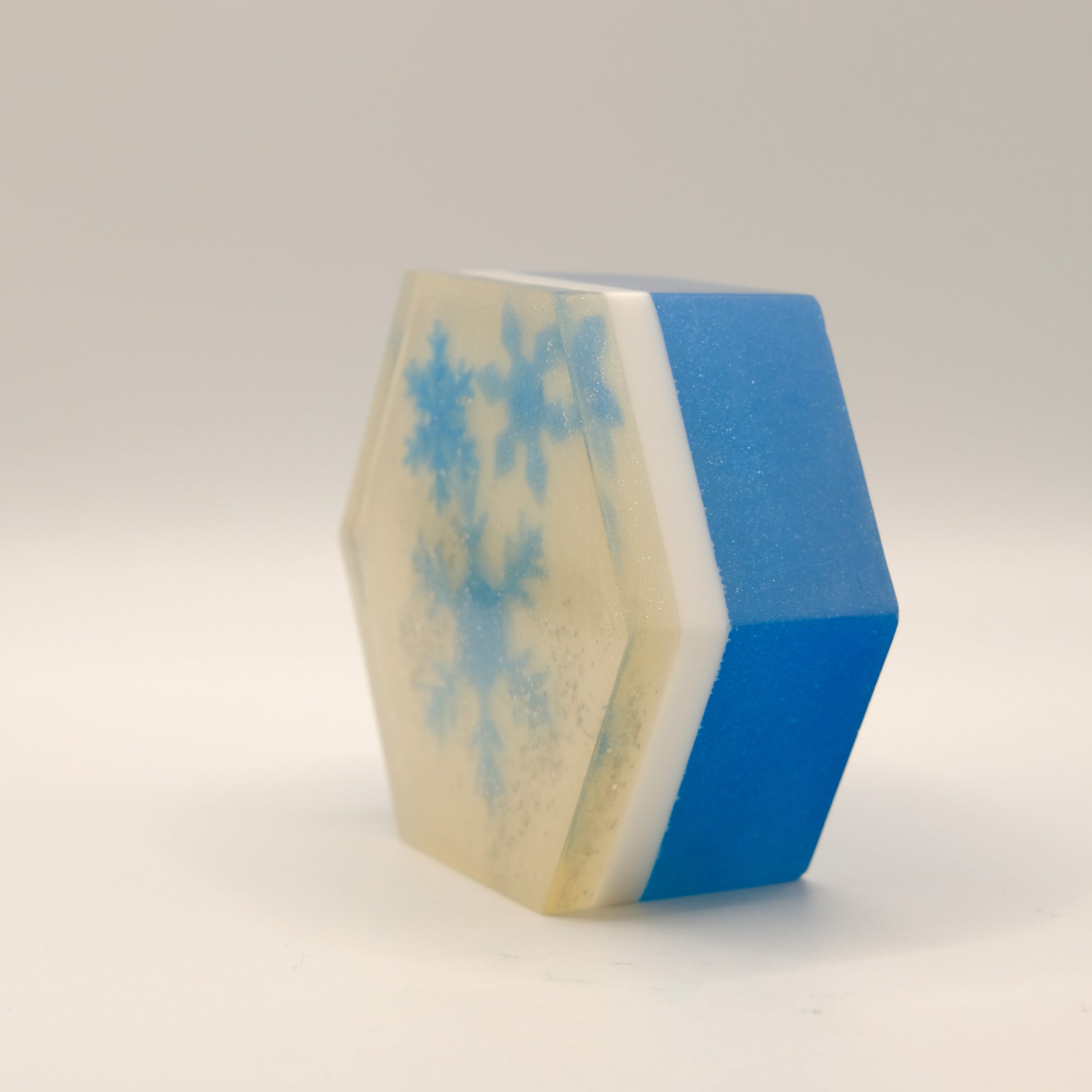 Hexagonal block with blue and white pattern on a white background