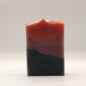 Three layered soap bar with black purple and red on a white background