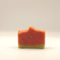 Two-layered soap bar with red and green colors on a white background