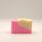 Two-tone pink and beige soap bar on a light background