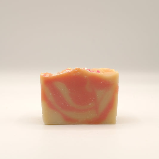 Swirled soap bar with red and beige on a white background