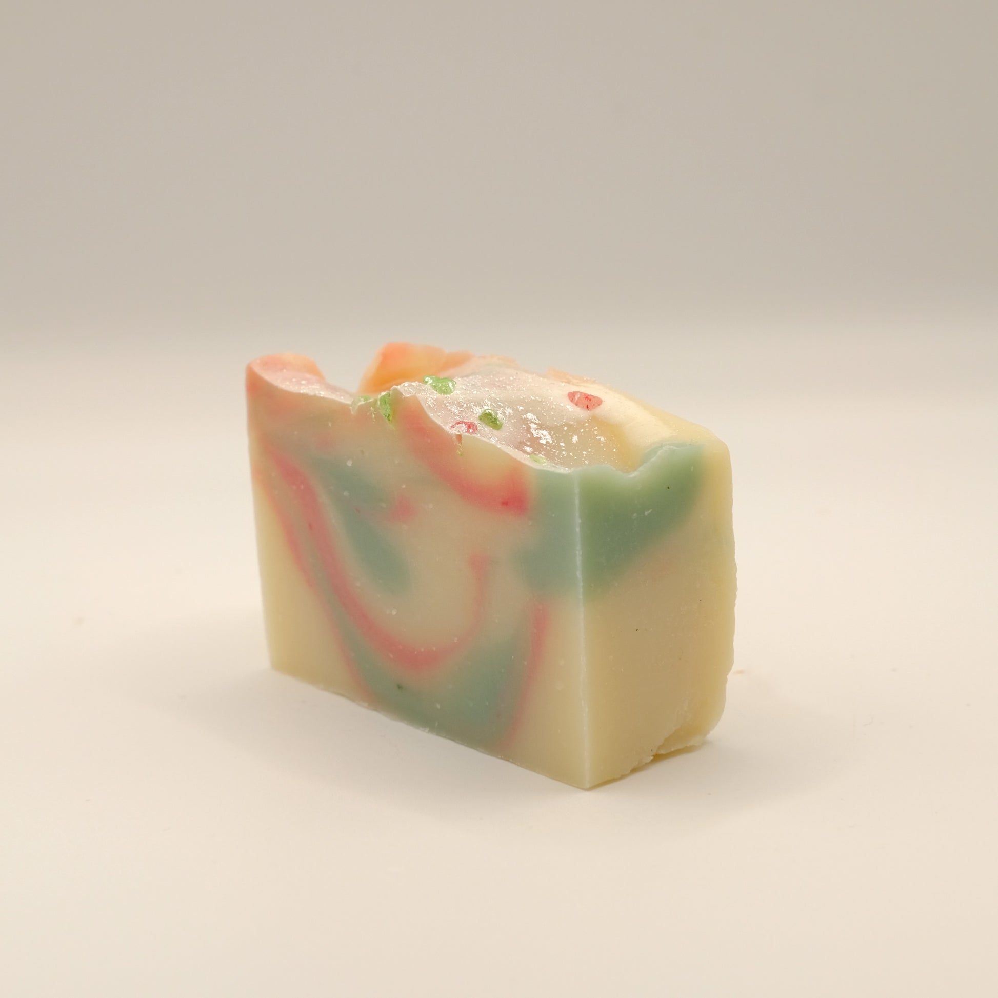 Colorful soap bar with swirl pattern on a light background