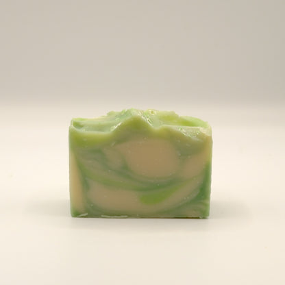 Green and beige swirled soap bar on a white background
