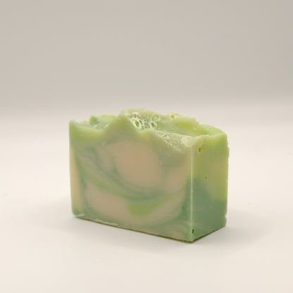 Green and white swirled soap bar on a light background