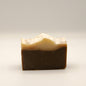 Two-layered soap bar with a dark bottom and light top on a white background