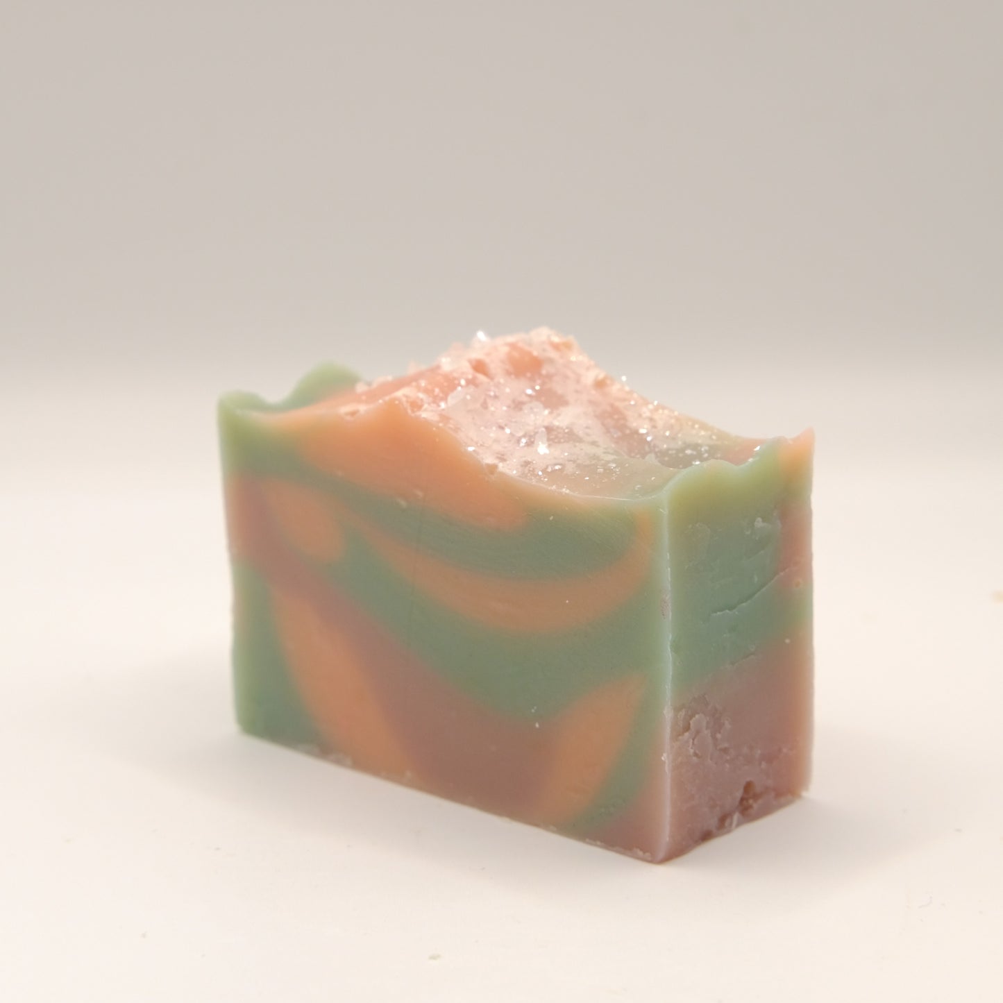 Colorful soap bar with blue, orange, and pink hues on a white background