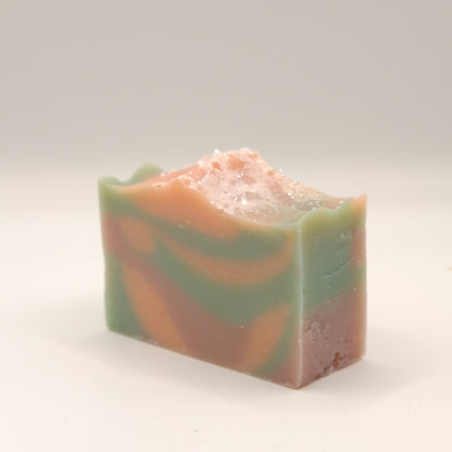 Colorful soap bar with blue, orange, and pink hues on a white background