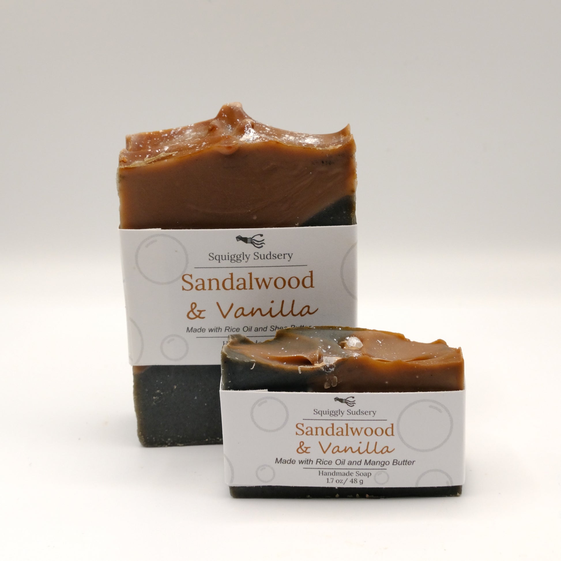 Two bars of Sandalwood & Vanilla soap with packaging on a white background