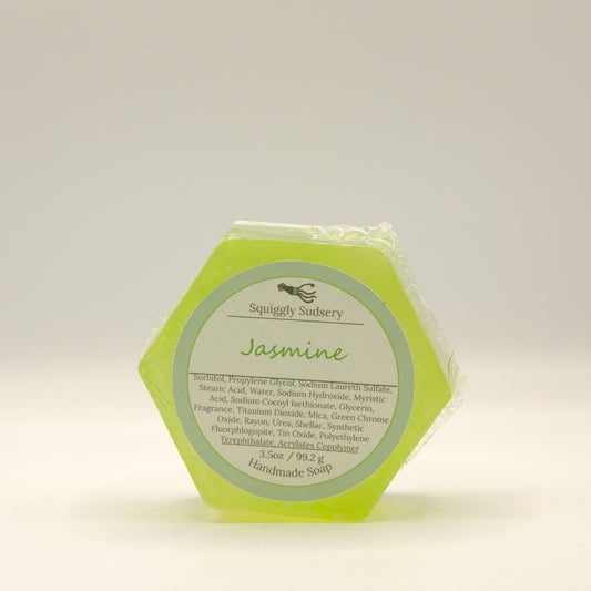Hexagonal yellow-green soap with a label on a light background