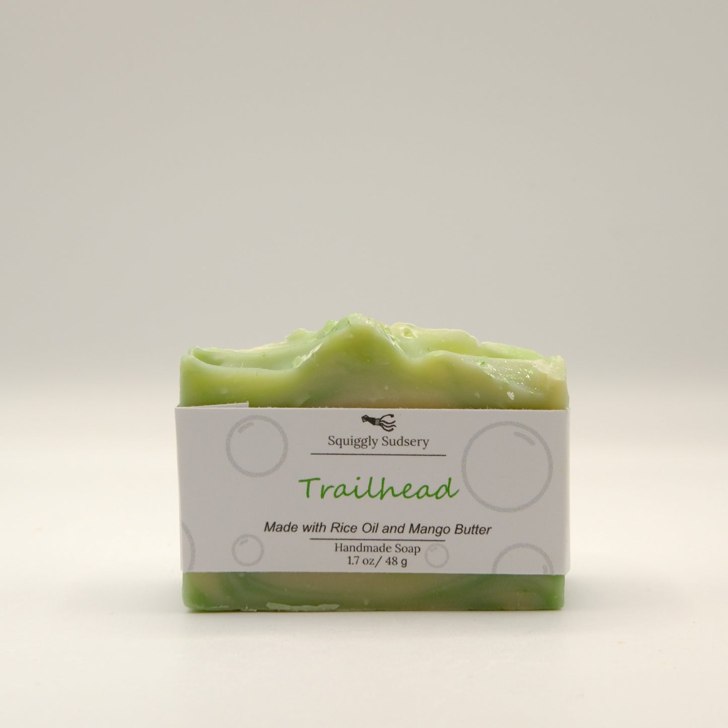 Green soap bar with packaging labeled 'Trailhead' on a light gray background