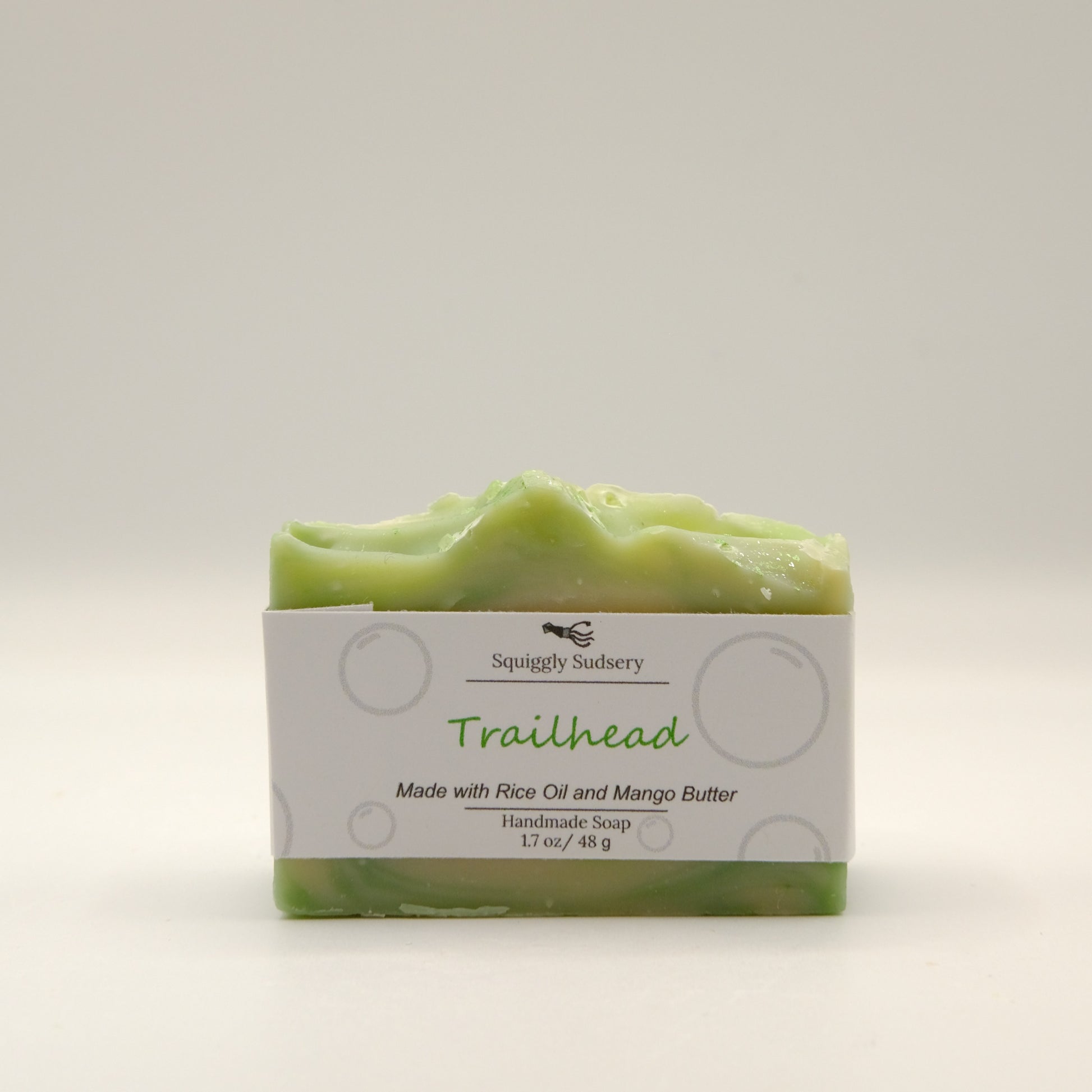 Green soap bar with packaging labeled 'Trailhead' on a light gray background
