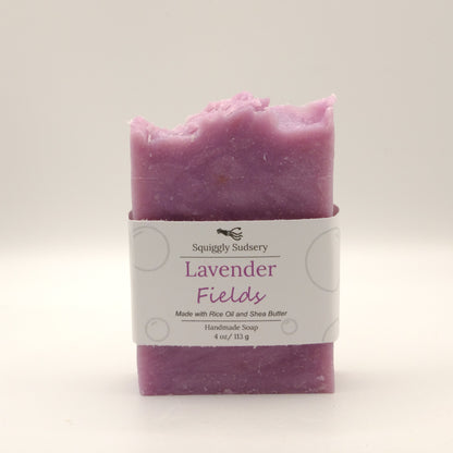 Purple soap bar with a white label on a light gray background