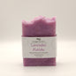Purple soap bar with a white label on a light gray background