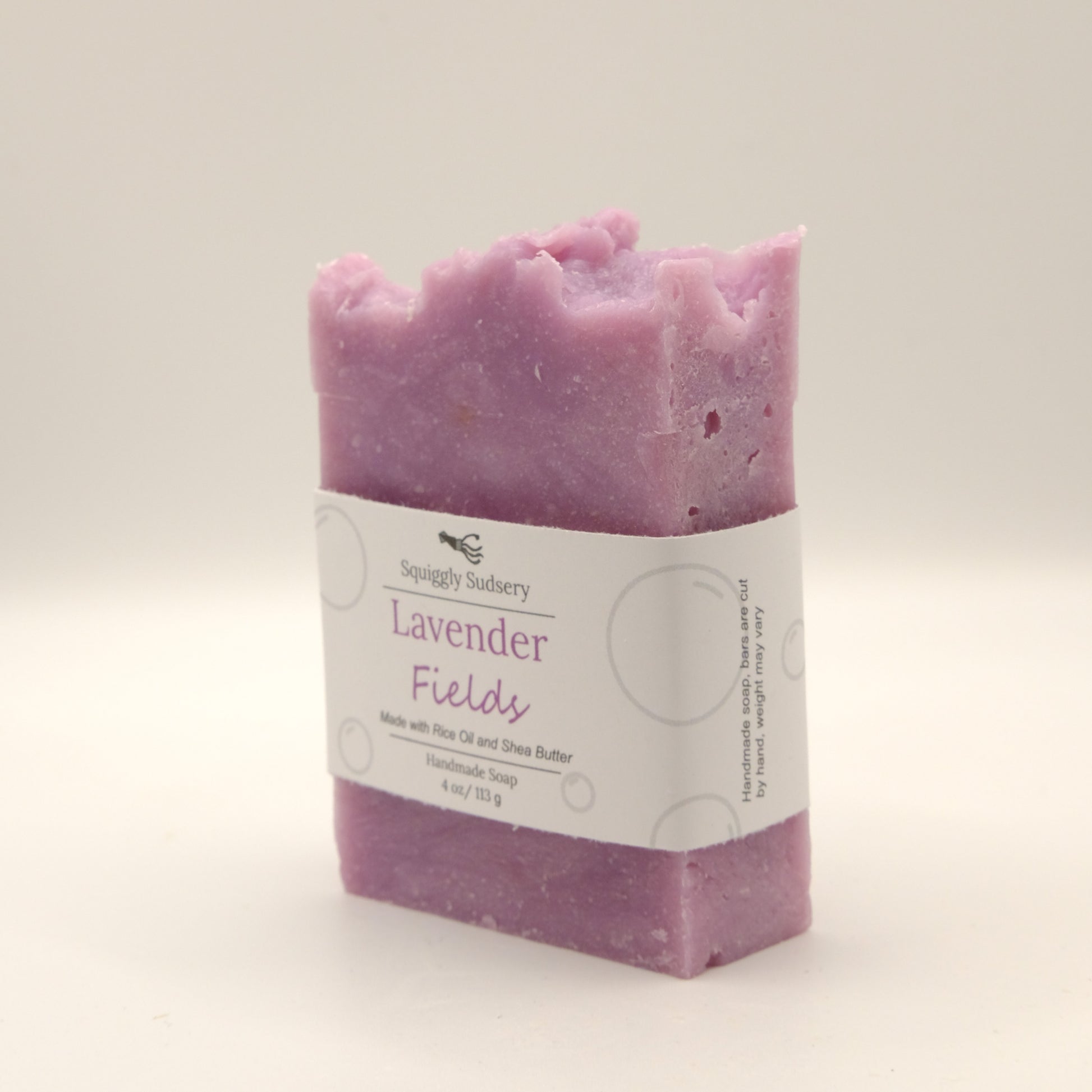 Purple soap bar with a label on a light gray background