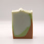 Bar of soap with green and brown gradient on a white background