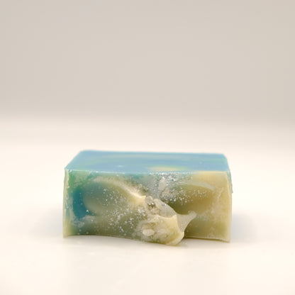 Bar of soap with green and blue gradient on a white background