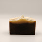 Bar of soap with a two-tone brown and beige color on a light gray background