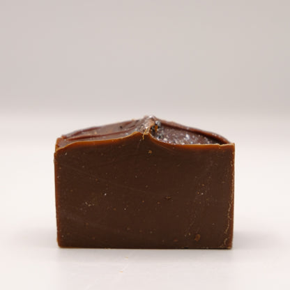 Dark brown bar of soap on a white background