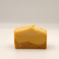 Yellow soap bar on a light gray background