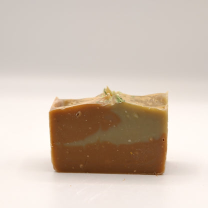 Bar of soap with a natural, slightly rough texture on a white background