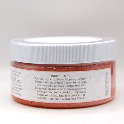 Jar of red sugar scrub with a white lid on a light gray background