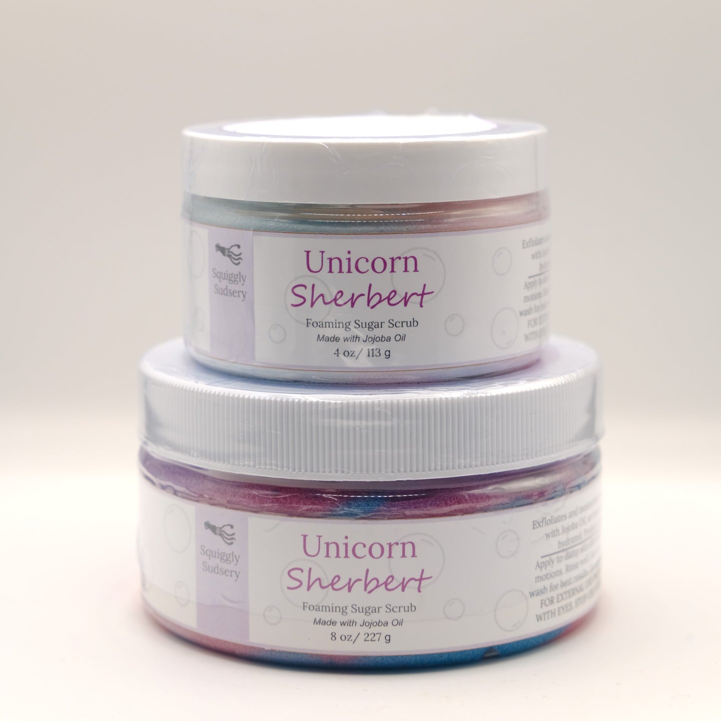 Two jars of Unicorn Sherbert foaming sugar scrub on a white background