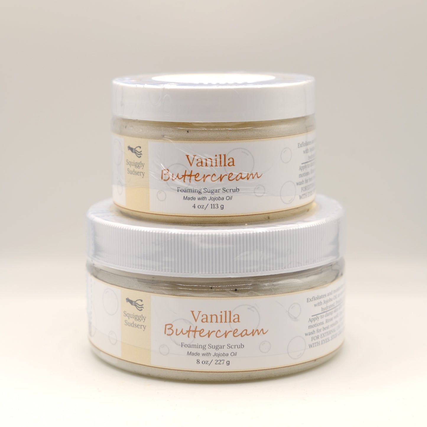 Two jars of Vanilla Buttercream body scrub on a light background