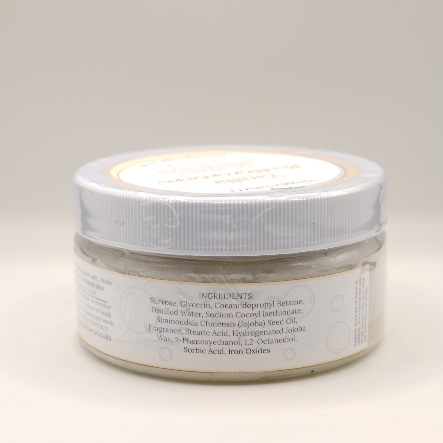 One jar of Vanilla Buttercream body scrub on a light background