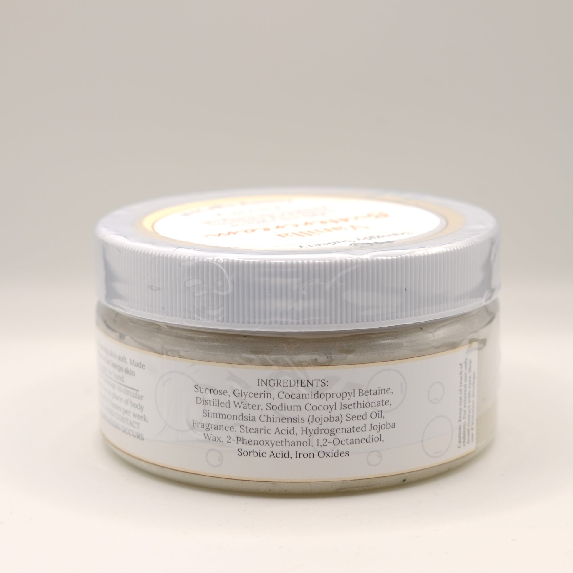 One jar of Vanilla Buttercream body scrub on a light background