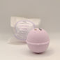 Bath bomb and packaging on a light gray background