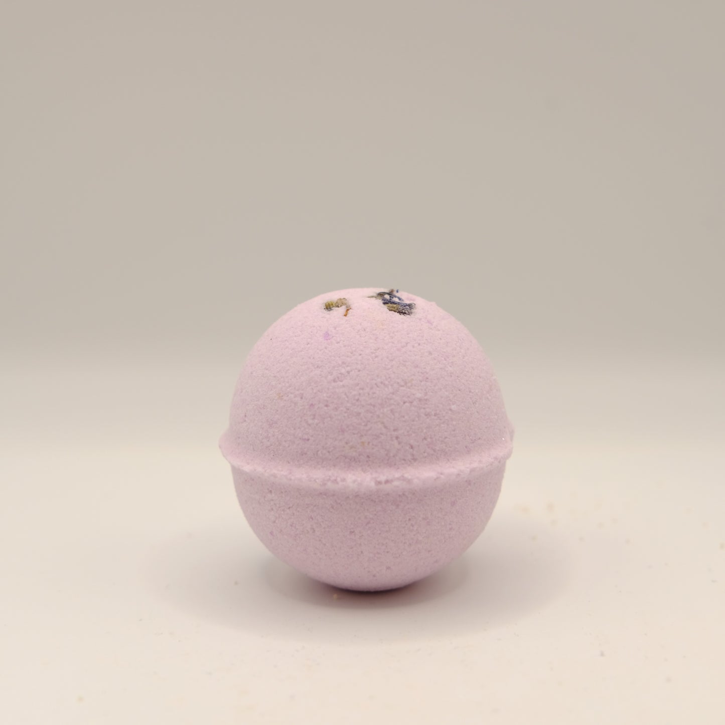 Purple bath bomb on a beige background