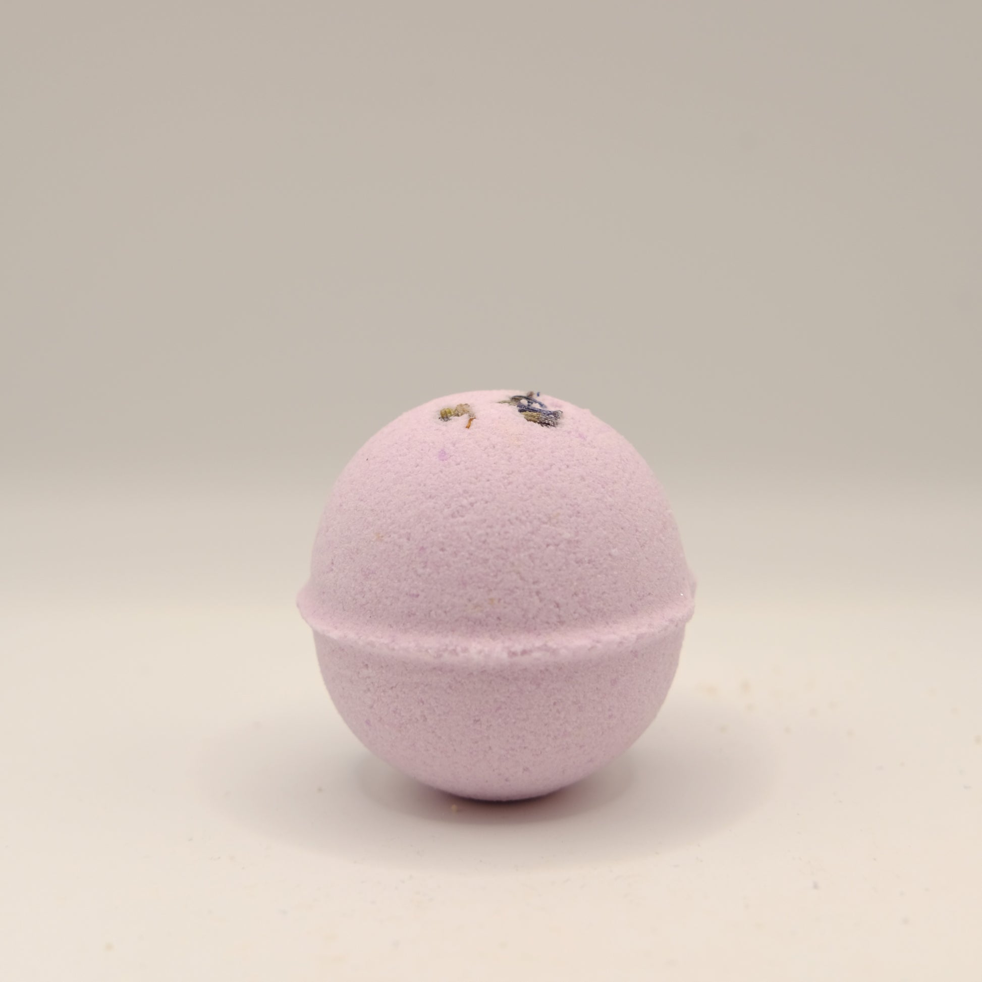 Purple bath bomb on a beige background