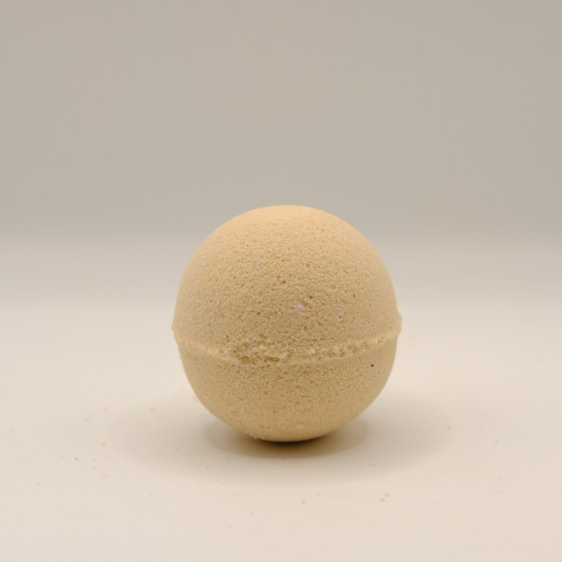 Beige bath bomb on a beige background