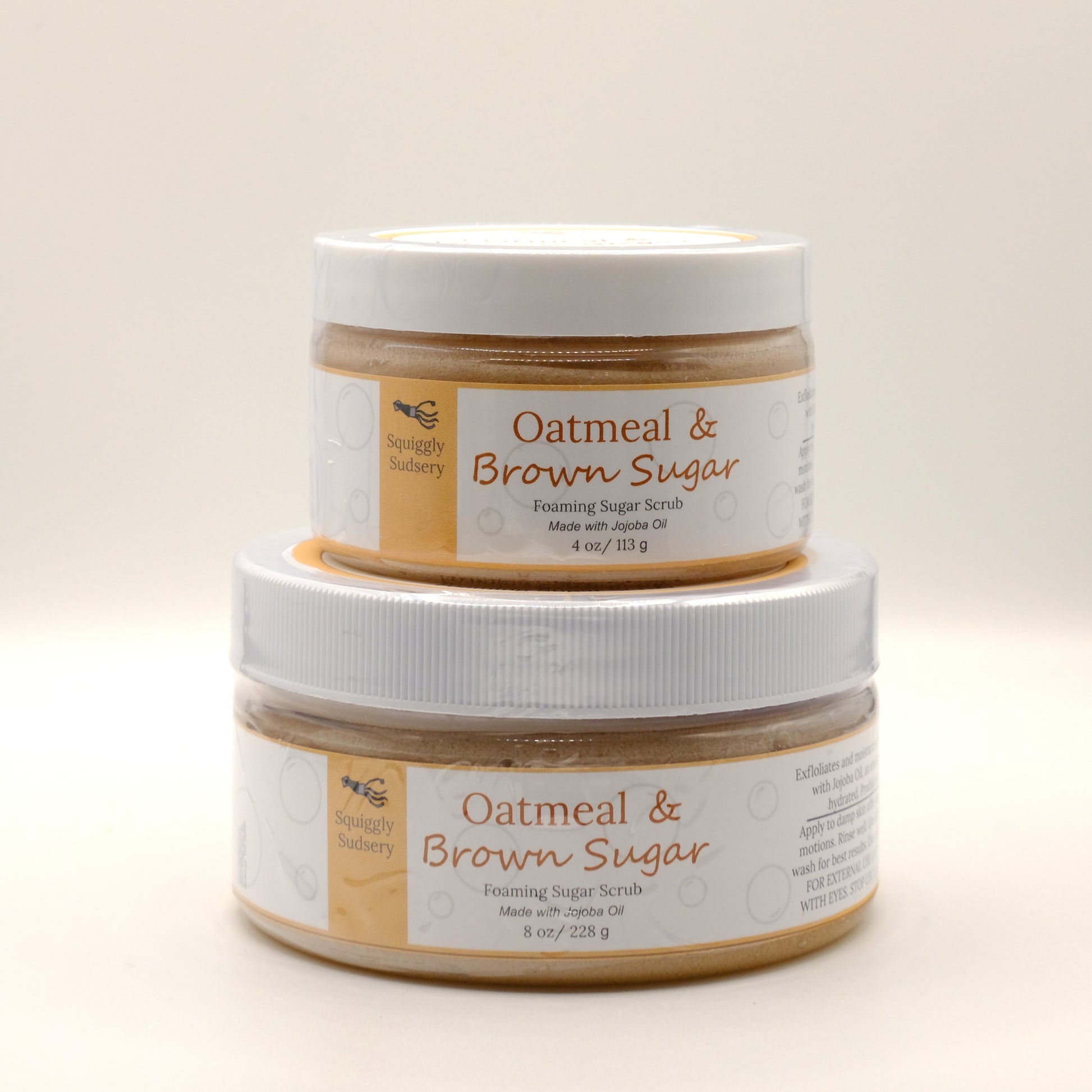 Two stacked jars of Oatmeal & Brown Sugar Foaming Sugar Scrub on a light background