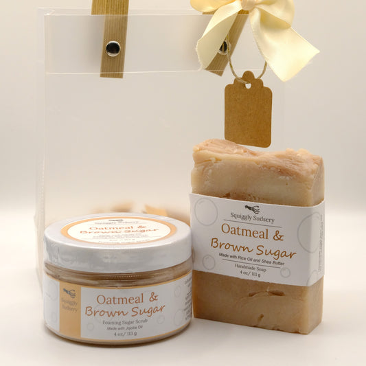 Oatmeal & Brown Sugar soap and jar of foaming sugar scrub with gift bag in the back, all on a white background