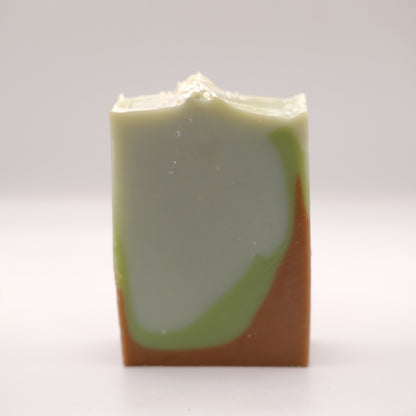 Bar of soap with green and brown gradient on a white background