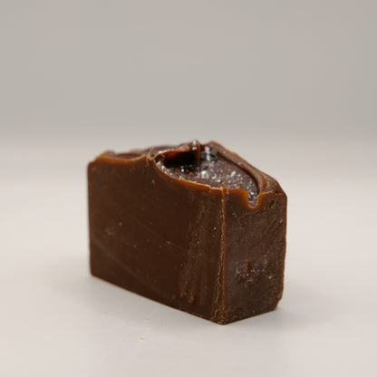 Dark brown bar of soap on a white background